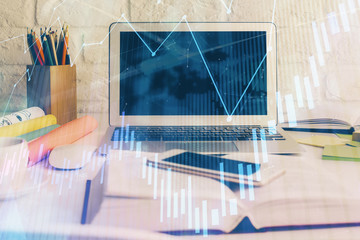 Naklejka premium Stock market graph on background with desk and personal computer. Multi exposure. Concept of financial analysis.