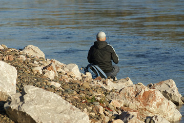 Fototapeta na wymiar A fisherman is fishing on the river