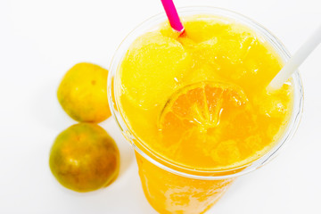 Slush ice with orange in Plastic Cup on background.