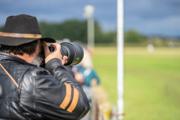Photographer shooting at an air show.Race Day at Shuttleworth.