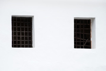 Close up Window with iron bar grill in stone wall