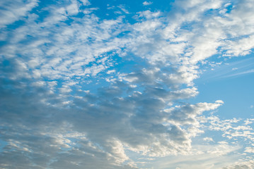 Blue sky with clouds and sun.