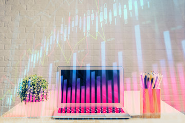Double exposure of chart and financial info and work space with computer background. Concept of international online trading.