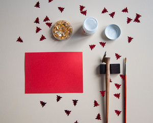 Greeting card Christmas mockup. Red paper invitation, gold, oblique pen. New year decorated...