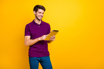 Portrait of his he nice attractive cheerful cheery content guy using digital ebook spending free...