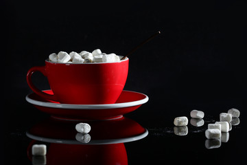 A large red cup with coffee and slices of marshmallows. View from above. Copy space. Still life...