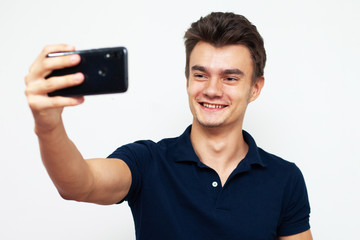 young man with mobile phone taking a selfie