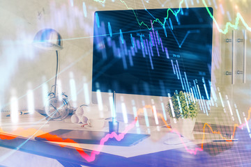 Stock market graph on background with desk and personal computer. Double exposure. Concept of financial analysis.