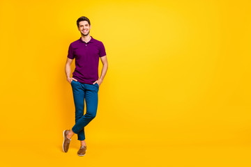 Fototapeta na wymiar Full length body size view of his he nice attractive cheerful cheery glad content guy crossed legs isolated over bright vivid shine vibrant yellow color background