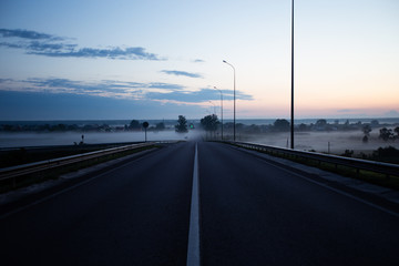 Noised Summer country road with fog. Rural up hill, vintage , environment Nature Asphalt road.