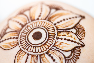 Drawing process of henna mehndi ornament on womans head