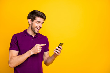 Portrait of his he nice attractive cheerful cheery glad guy wearing violet shirt holding in hands...