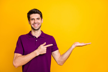 Portrait of his he nice attractive cheerful cheery glad guy wearing lilac shirt pointing forefinger...