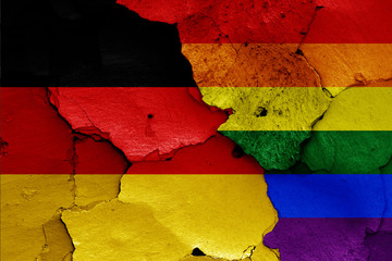 flags of Germany and LGBT painted on cracked wall
