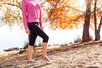 Healthy Lifestyle. Young woman standing near lake autumn season posing close-up