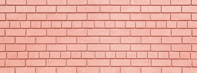 Fototapeta premium Coral painted brickwork wide background. Brick block widescreen texture. Peach color wall panorama