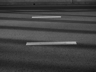 white line on asphalt road with shadow black and white style