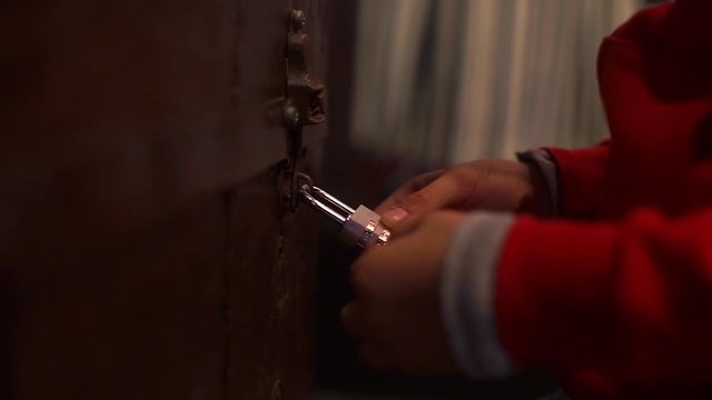 child at night tries to open the combination lock