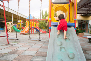 Happy Asian baby child girl aged of 2 years old playing with a slider toy. She practice to crawling...