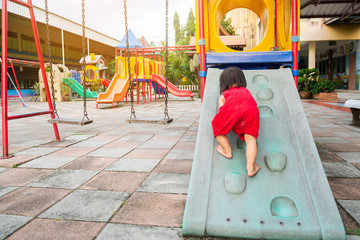 Happy Asian baby child girl aged of 2 years old playing with a slider toy. She practice to crawling...