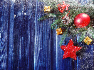 christmas background with decorations and snow on wooden board