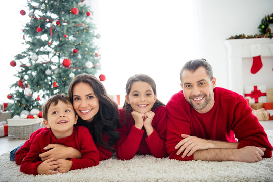 Portrait of four nice attractive lovely charming idyllic dreamy cheerful cheery affectionate full big family celebrating newyear spending weekend rest relax in light white interior living-room