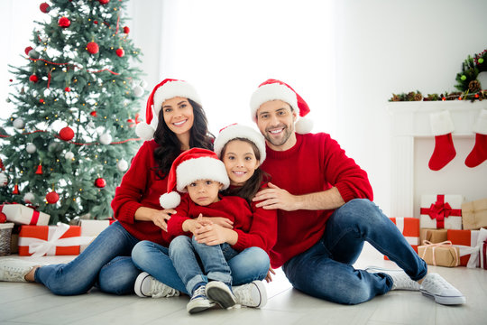Portrait of four nice attractive idyllic affectionate cheerful big full adopted foster family celebrating newyear enjoying winter december vacation weekend in light white interior living-room