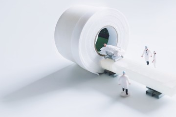 Close up miniature people doctor with CT scan on white background.