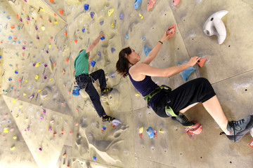 young sporty couple of climbers in a climbing hall