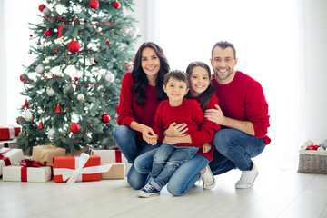 Full size photo of big full family pretty mom dad schoolgirl hug sitting near gift box present for christmas time x-mas holidays in house indoors
