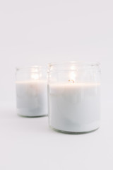 Burning candles in glass candlesticks