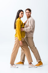 handsome man standing with stylish girl on white