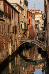 Fototapeta na wymiar Venice, foreshortening of the city with a small bridge over a canal of the Venetian lagoon and old houses. UNESCO world heritage site, Italy, Europe