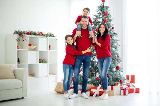 Full body photo of big full lovely family of schoolgirl cuddle her daddy carry younger child and mommy celebrate christmas time x-mas holidays in house with gifts indoors