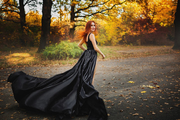 Naklejka premium Woman in long dress runs through a forest