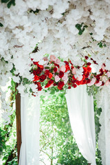 Fototapeta na wymiar Arch for the wedding ceremony, decorated with cloth and flowers