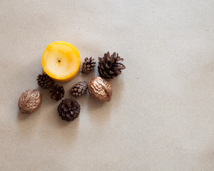 Autumn composition mock up on craft paper background. Candle, walnuts, cones. Fall, thanksgiving day concept. Flat lay, top view, copy space.