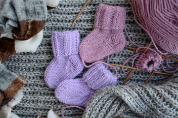Fototapeta na wymiar wool and knitting needles on grey background