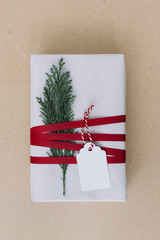 White gift box with cypress branch on table