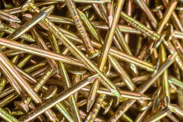 Texture of yellow nails on red background.