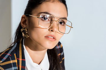 attractive young woman in glasses on white