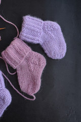 Pink and purple baby socks, made of warm and soft woolen yarn