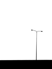 silhouette of street lamp post on expressway