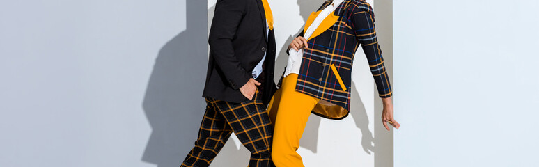 panoramic shot of man and girl standing on white and grey