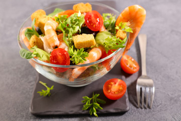 bowl of shrimp salad with tomato and avocado