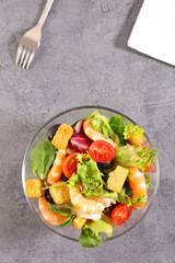 bowl of shrimp salad with tomato and avocado