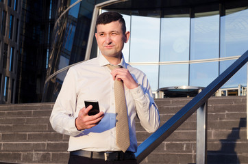 young handsome successful businessman, manager loosens tie, cannot breathe, asphyxiation. danger of suffocation. emotions, fatigue, solve problems, disappointment