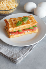 Chaffles with salmon. Egg and cheese waffles for breakfast. Keto diet. Cheese waffle.