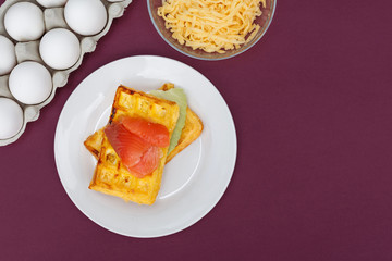 Chaffles with salmon. Egg and cheese waffles for breakfast. Keto diet. Cheese waffle.