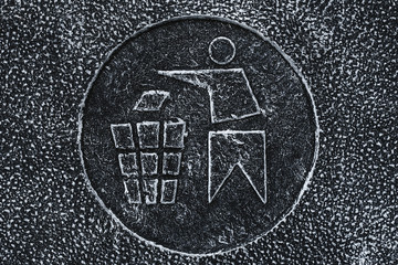 Symbol, engraving on wastebasket. Trash bin sign. Icon on gray stone surface.